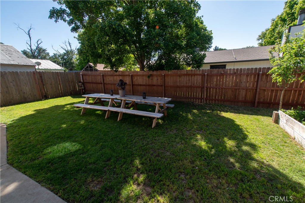 1 San Ramon Drive Chico, CA 95973 - Photo 30 of 42 a view of a backyard with wooden fence and a bench