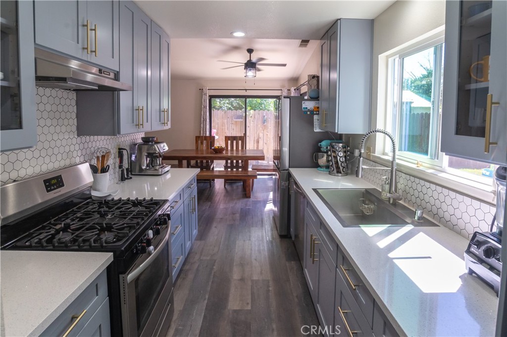 1 San Ramon Drive Chico, CA 95973 - Photo 3 of 42 a kitchen with lots of counter top space a sink appliances and cabinets