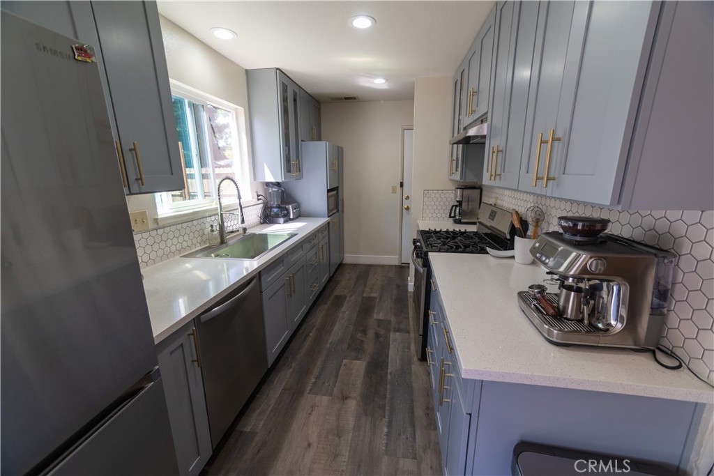 1 San Ramon Drive Chico, CA 95973 - Photo 7 of 42 a kitchen with a sink stove and cabinets