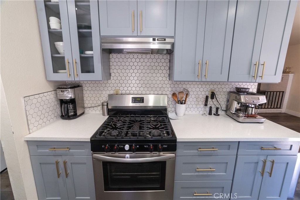 1 San Ramon Drive Chico, CA 95973 - Photo 8 of 42 a kitchen with granite countertop stainless steel appliances a stove a refrigerator a sink and cabinets