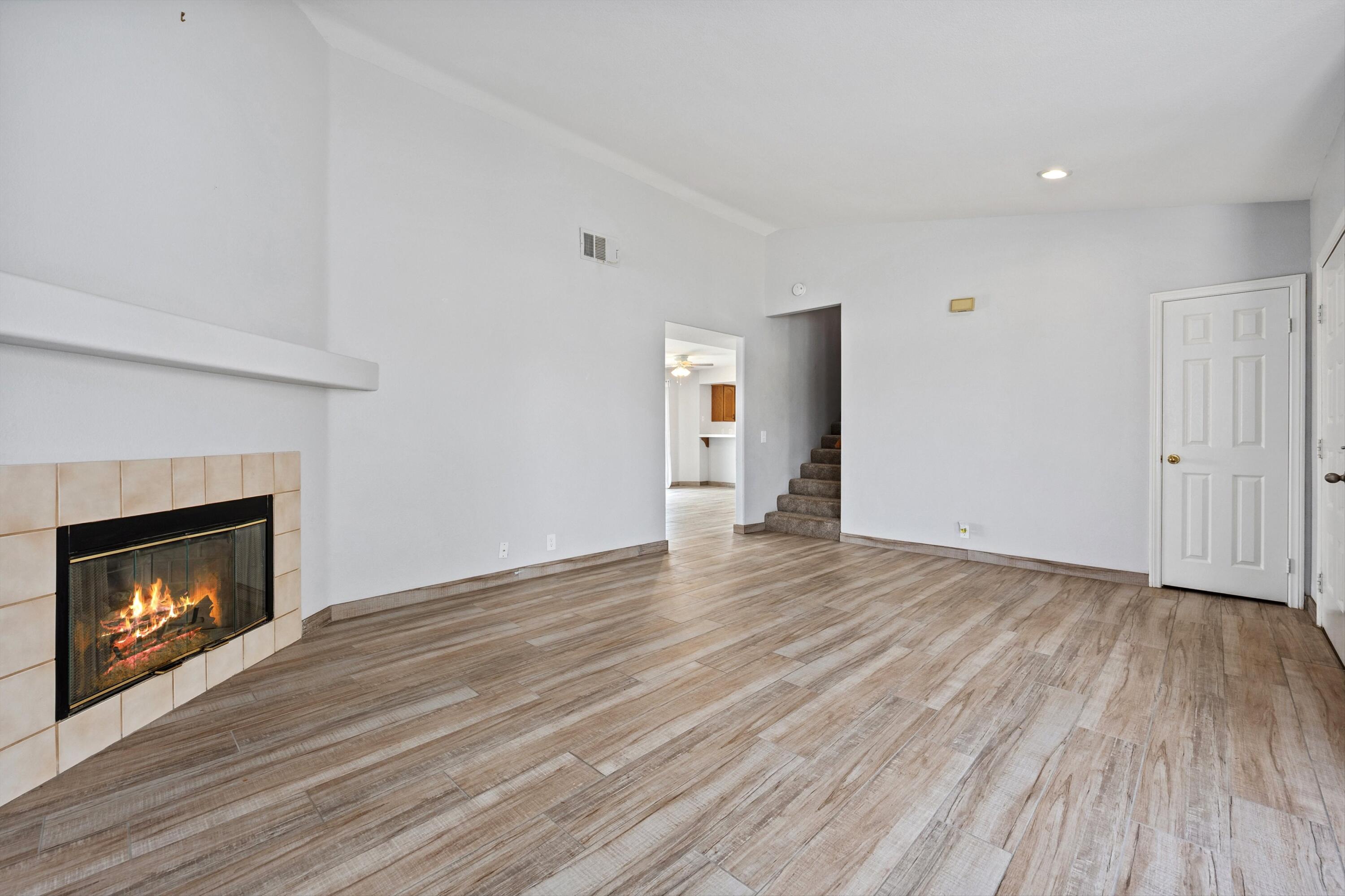 81064 Jessica Way Indio, CA 92201 - Photo 11 of 34 a view of an empty room with wooden floor fireplace and a window