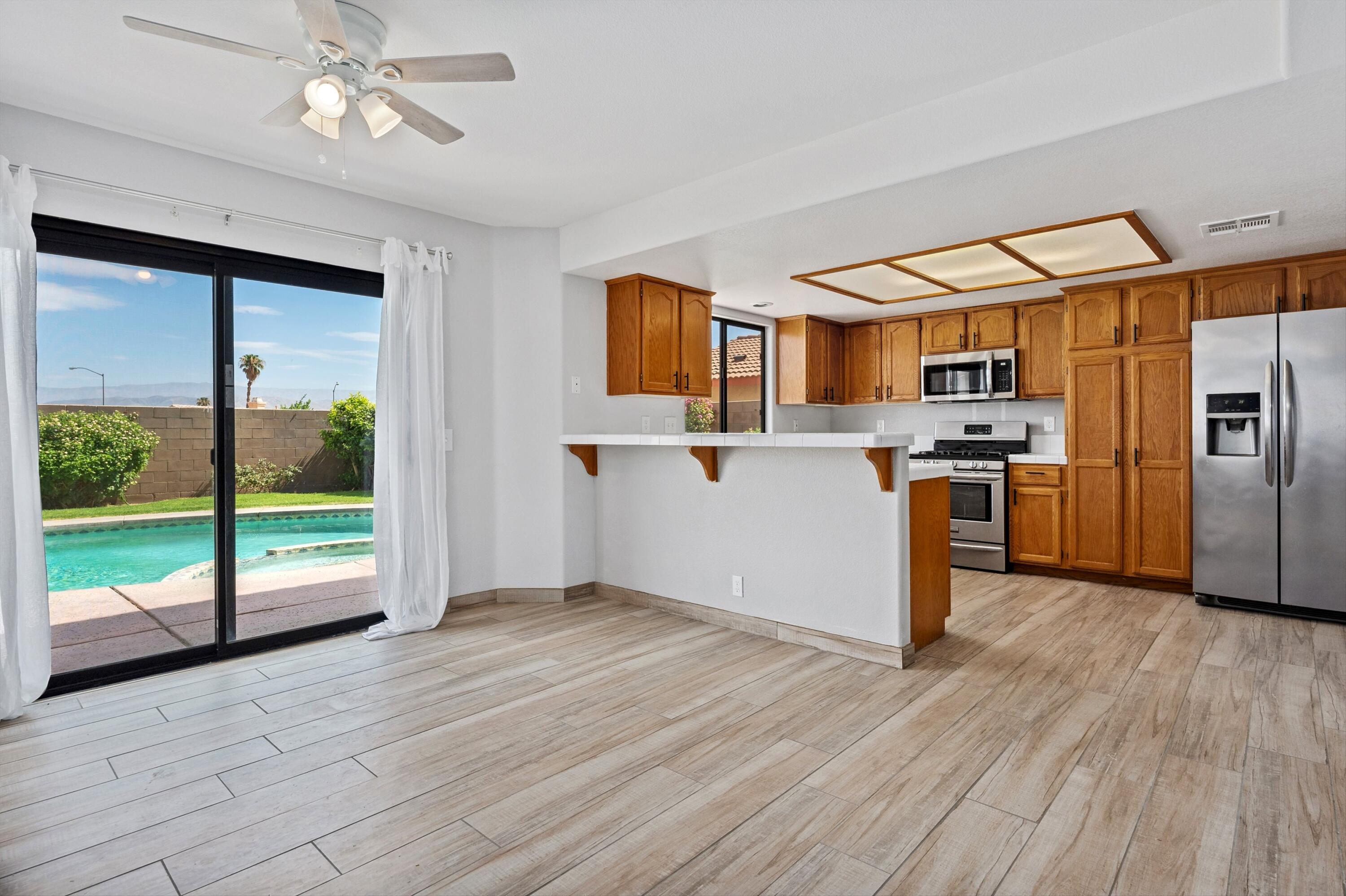 81064 Jessica Way Indio, CA 92201 - Photo 17 of 34 a kitchen with stainless steel appliances granite countertop a refrigerator and a stove top oven