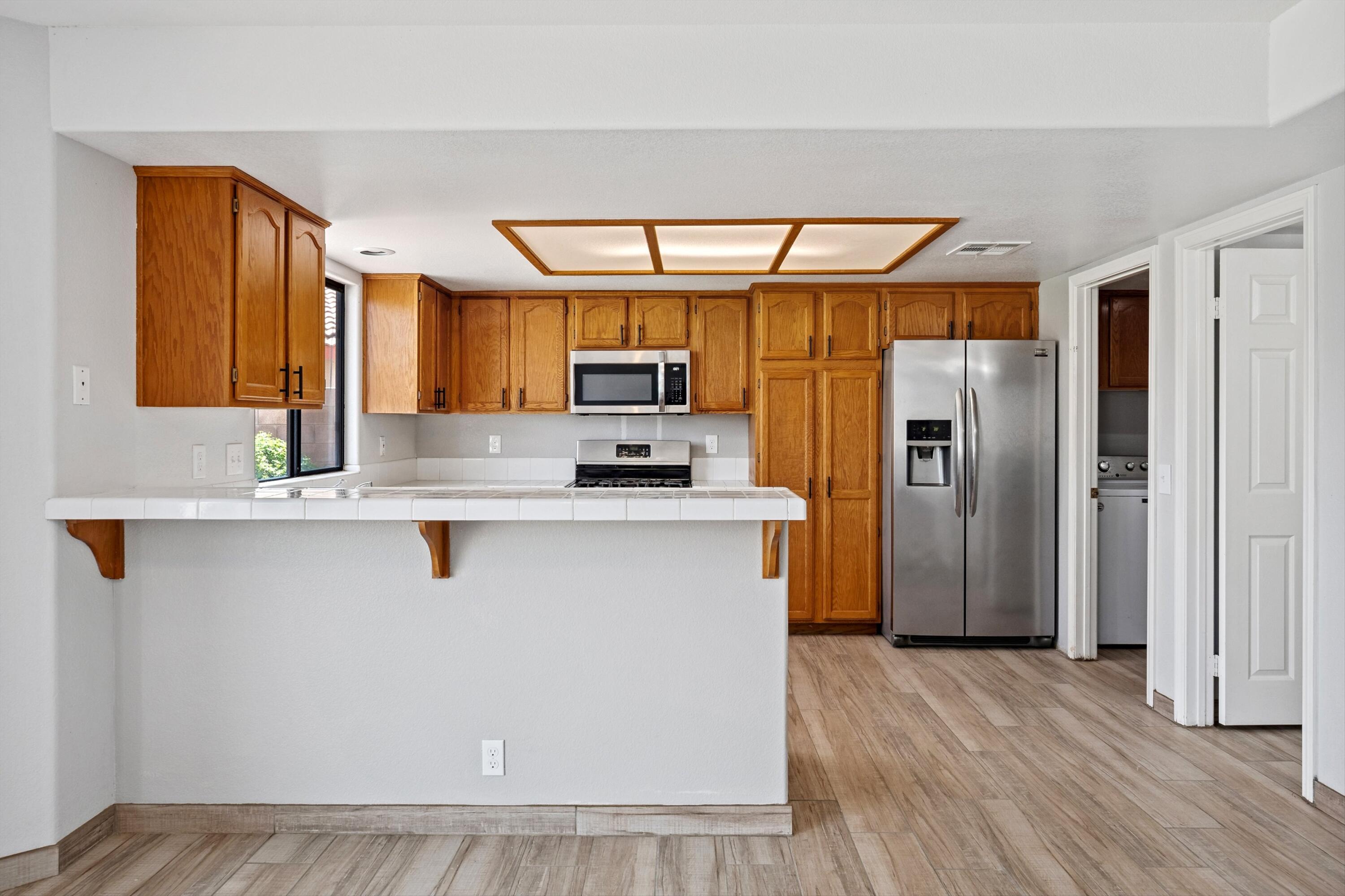 81064 Jessica Way Indio, CA 92201 - Photo 19 of 34 a kitchen with stainless steel appliances a refrigerator and a stove top oven