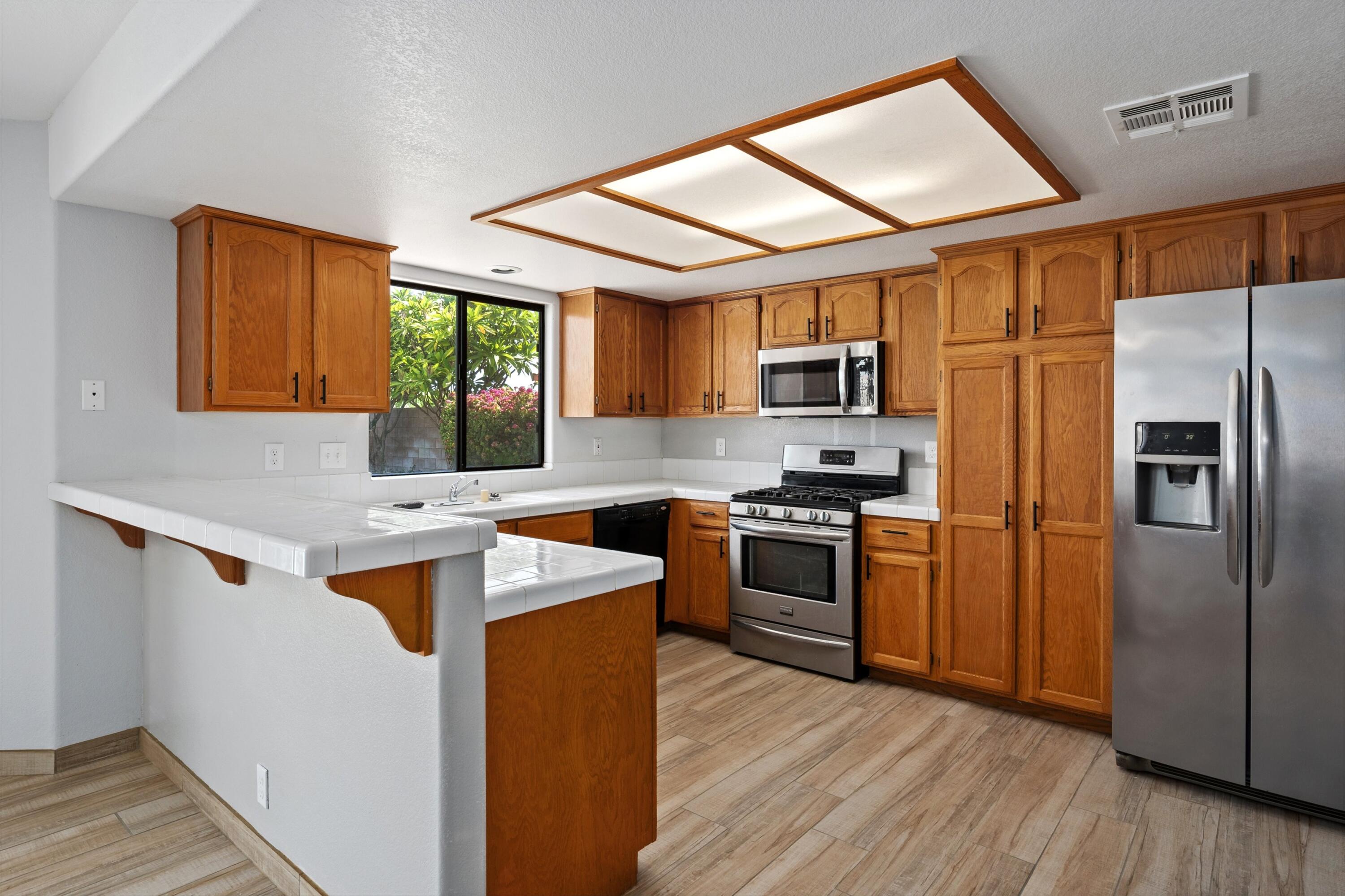 81064 Jessica Way Indio, CA 92201 - Photo 20 of 34 a kitchen with stainless steel appliances granite countertop a refrigerator sink and stove