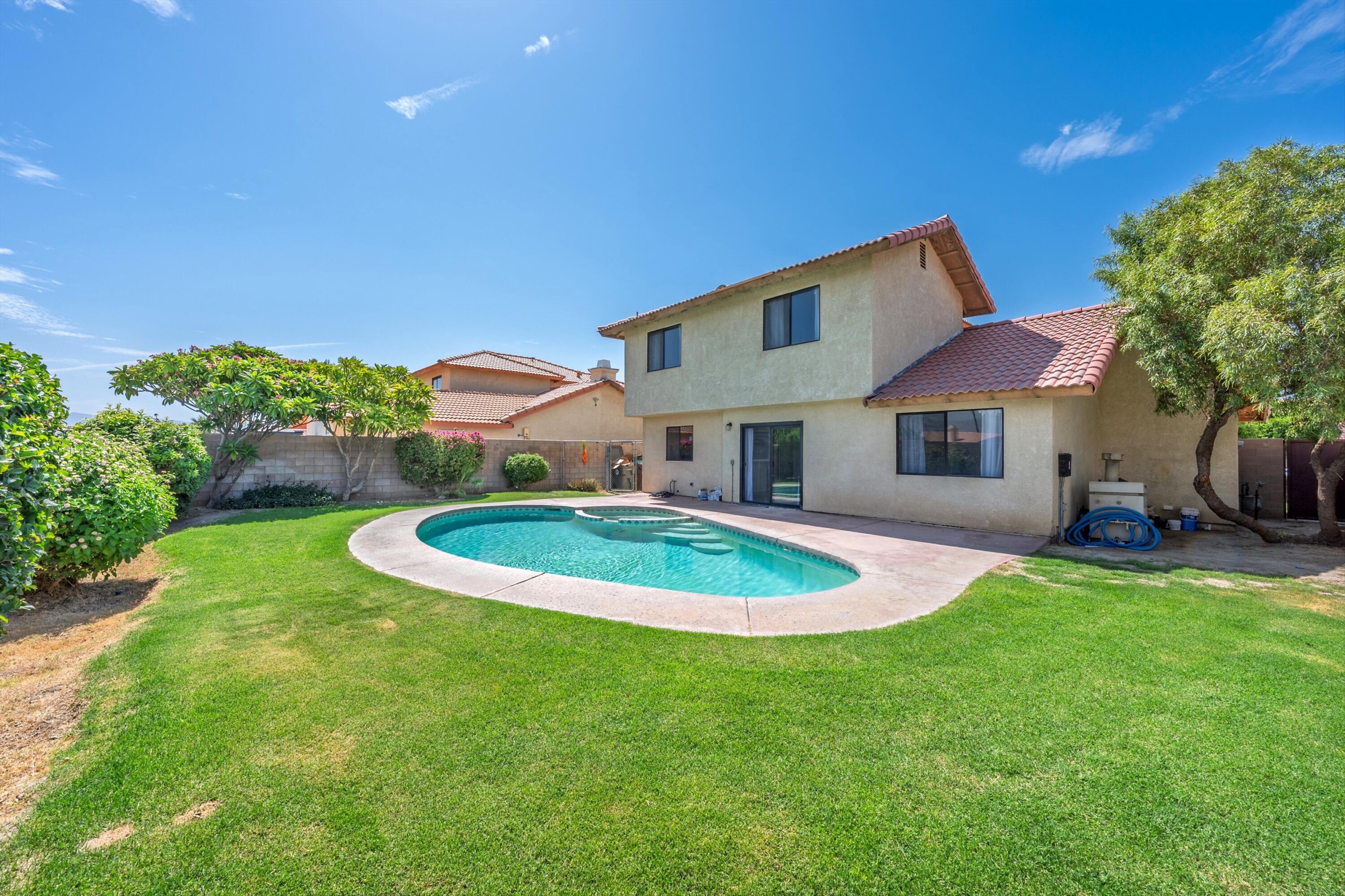 81064 Jessica Way Indio, CA 92201 - Photo 2 of 34 a backyard of a house with table and chairs