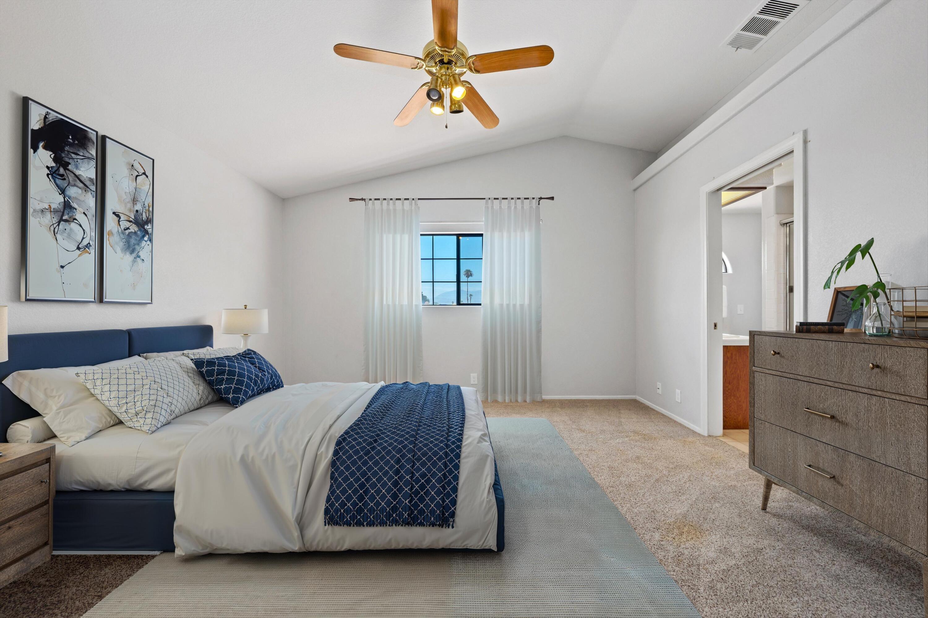 81064 Jessica Way Indio, CA 92201 - Photo 26 of 34 a bedroom with a large bed and ceiling fan