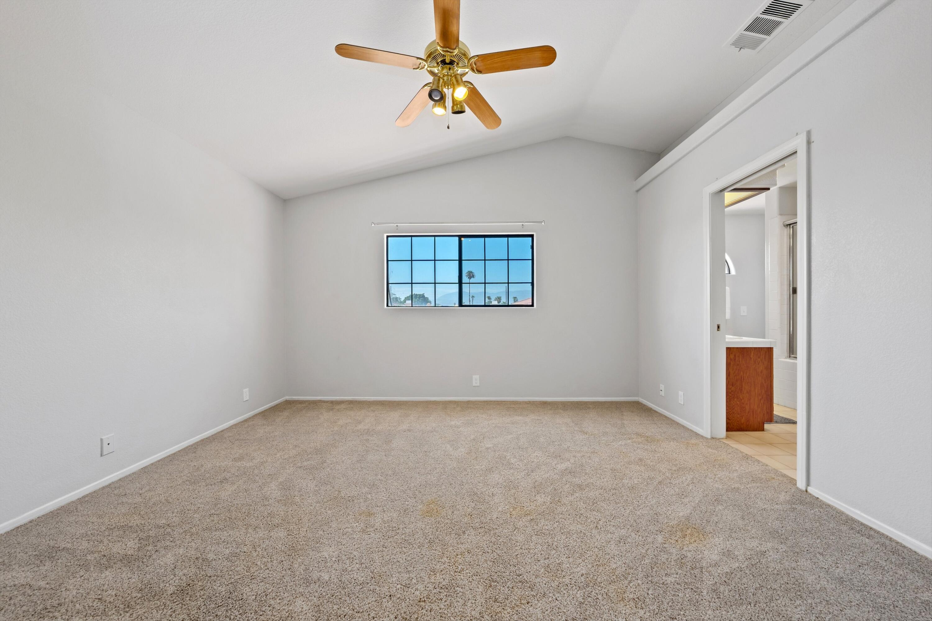 81064 Jessica Way Indio, CA 92201 - Photo 27 of 34 an empty room with windows and fan
