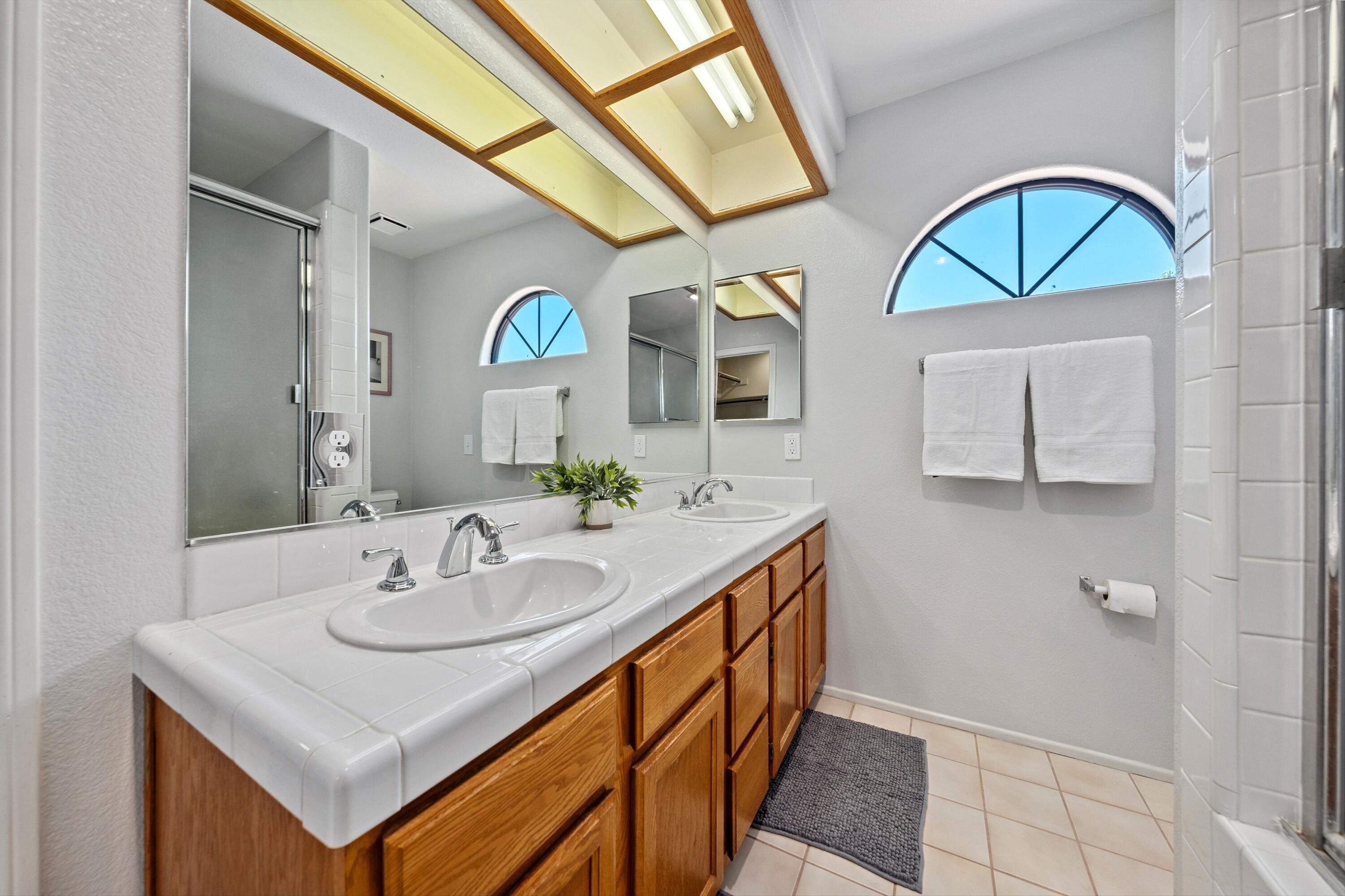 81064 Jessica Way Indio, CA 92201 - Photo 28 of 34 a bathroom with a sink a mirror and a window