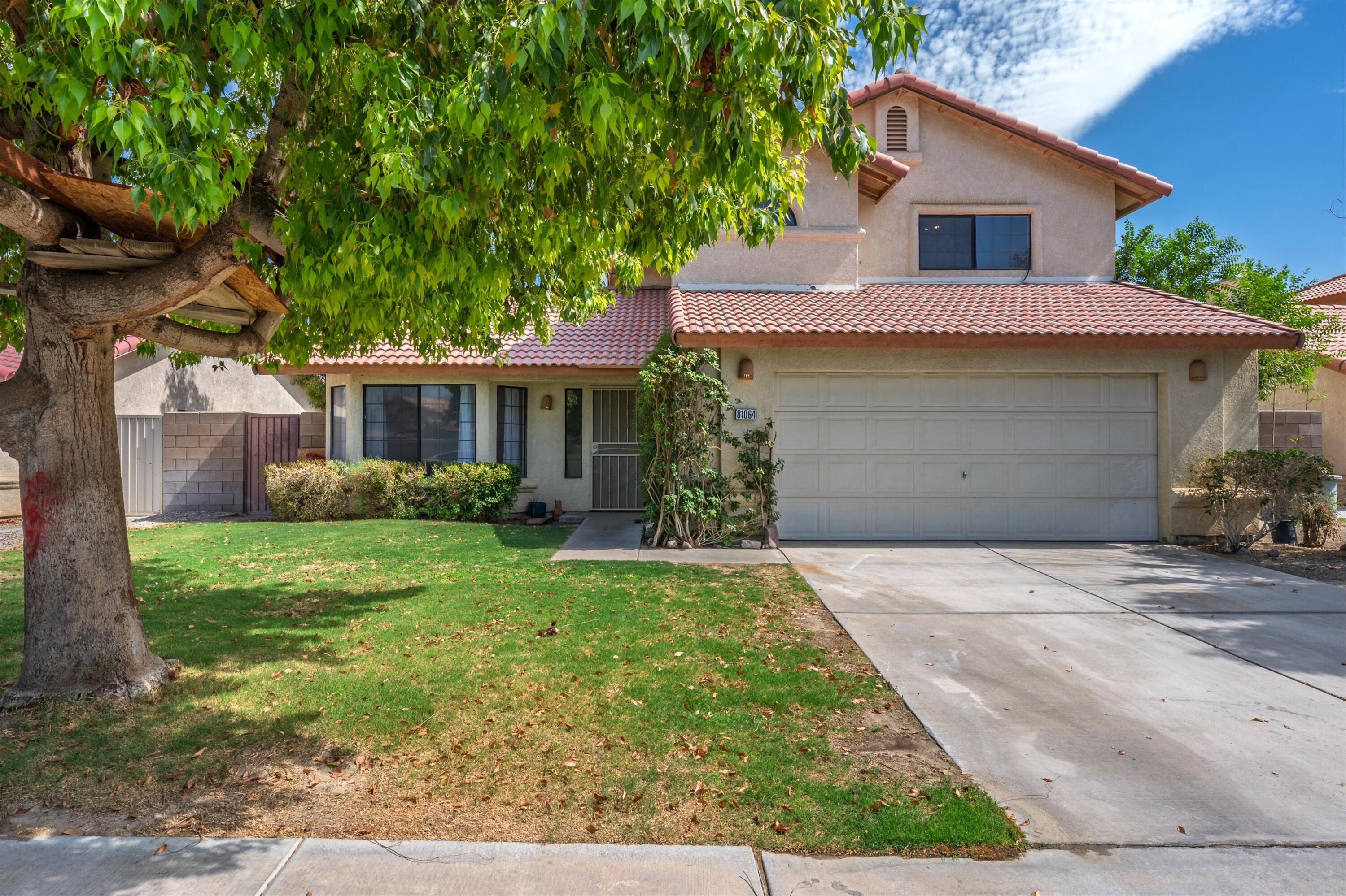 81064 Jessica Way Indio, CA 92201 - Photo 34 of 34 a front view of a house with a yard