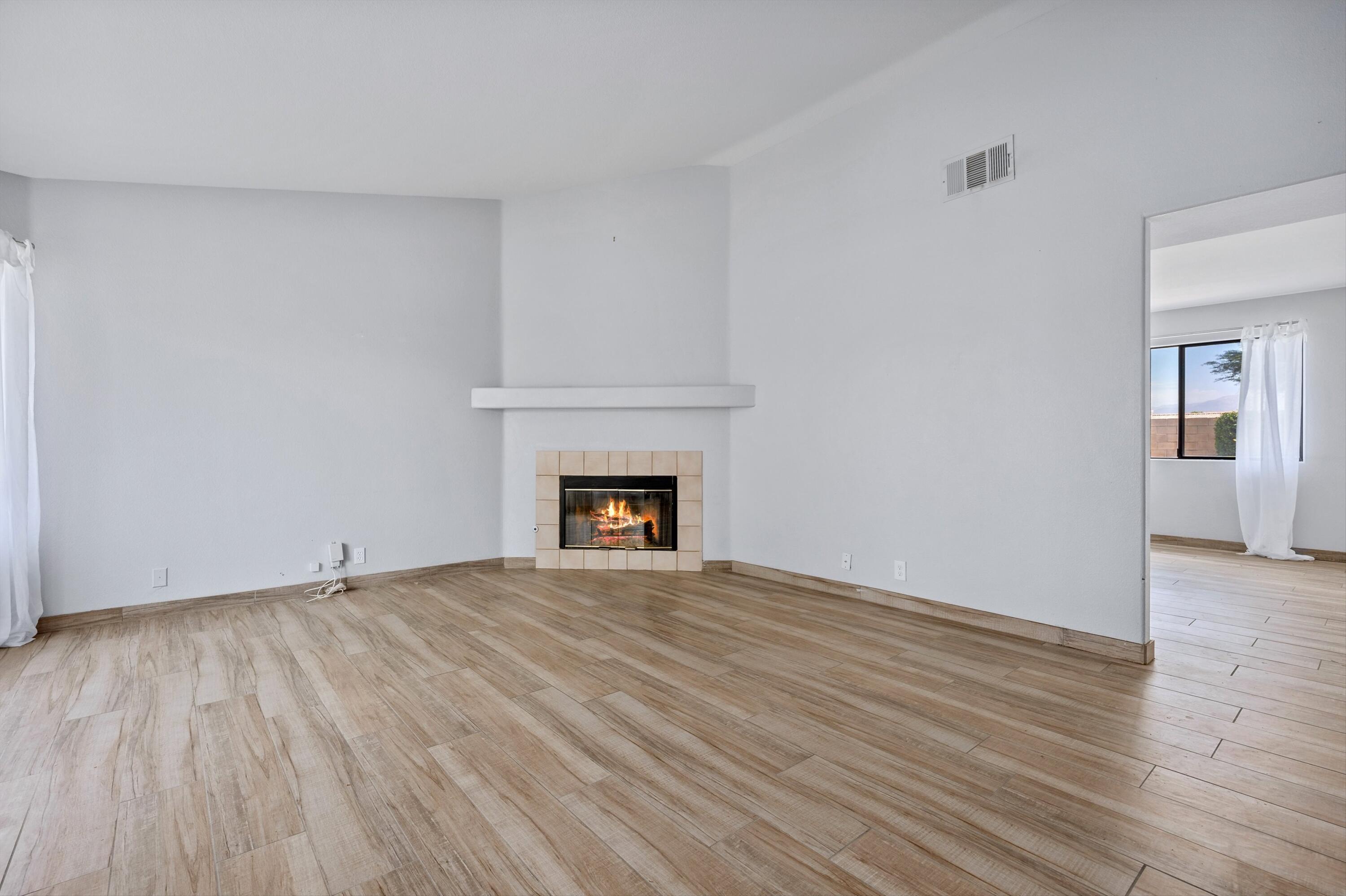 81064 Jessica Way Indio, CA 92201 - Photo 8 of 34 a view of an empty room with wooden floor fireplace and a window