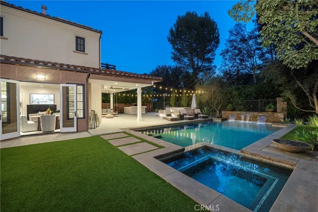 a view of a house with pool and sitting area