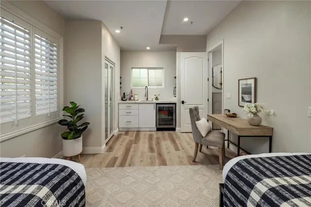 a bedroom with a bed and a potted plant