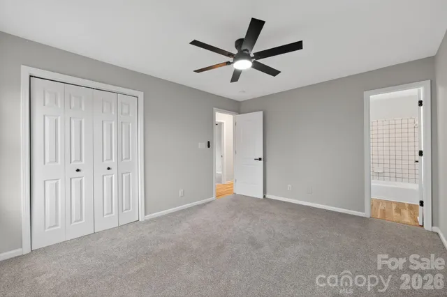 a view of a livingroom with a ceiling fan and wooden floor