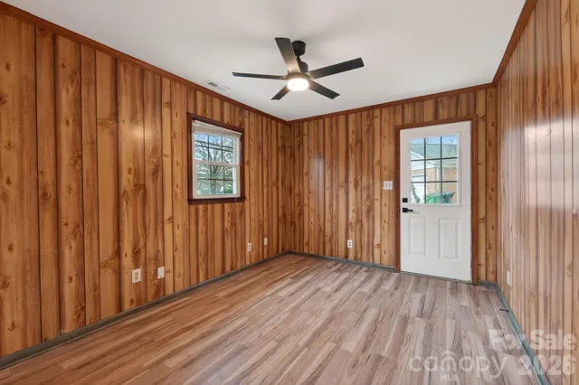 wooden floor in an empty room with a window