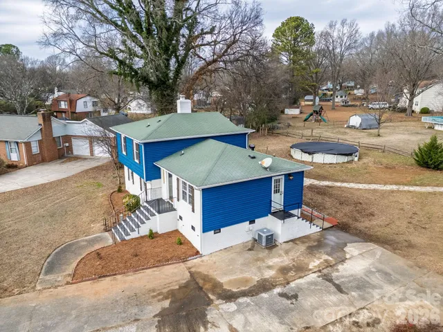 a view of a backyard with a patio and fire pit