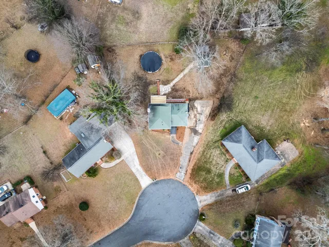 an aerial view of a house with outdoor space and sitting area