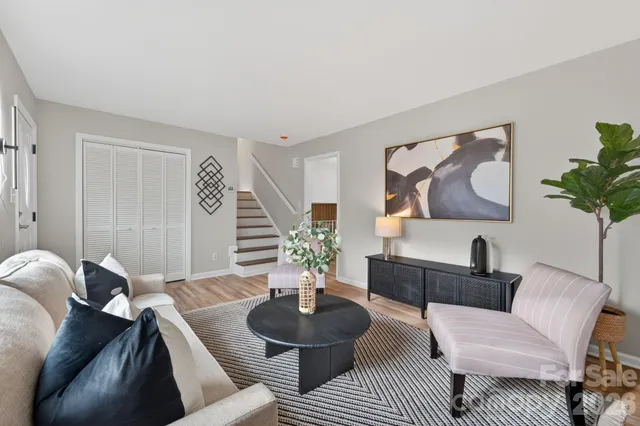 a living room with furniture and a potted plant