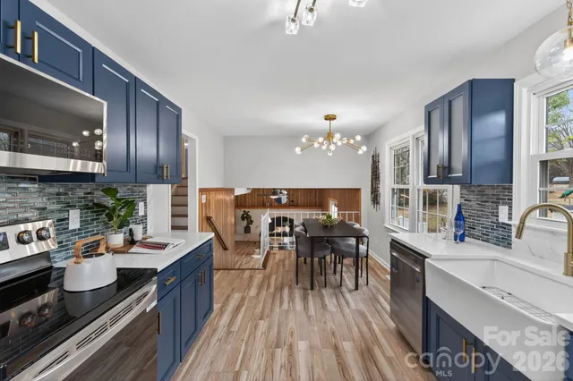 a view of a dining room with furniture kitchen and wooden floor