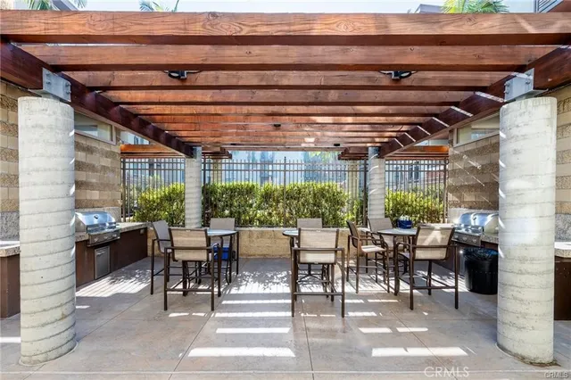 a living room with lots of furniture and view of kitchen