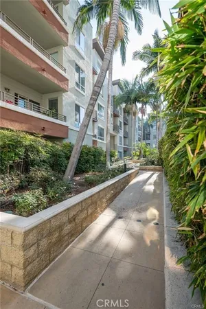 a front view of an apartment building with yard