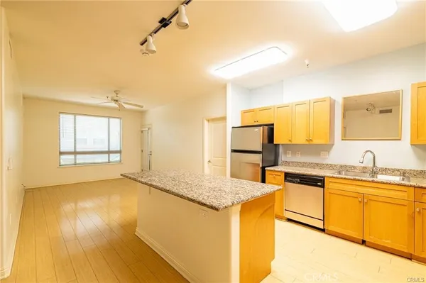 a living room with fireplace furniture and a large window