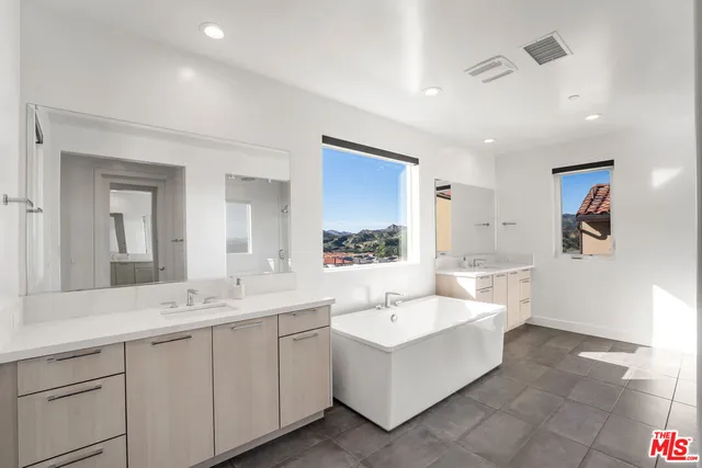 a bedroom with a bed and a computer on a table