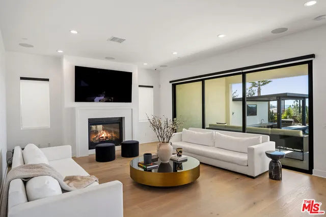 a living room with furniture a fireplace and a flat screen tv
