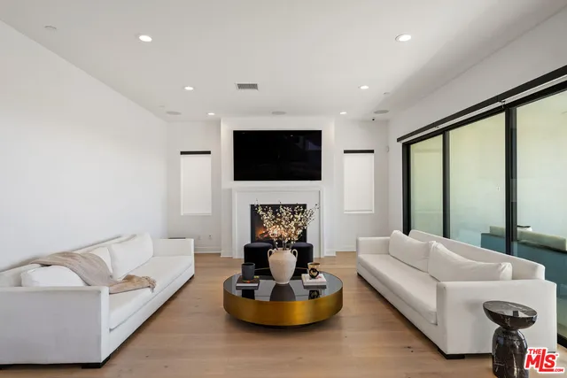 a living room with fireplace furniture and a flat screen tv