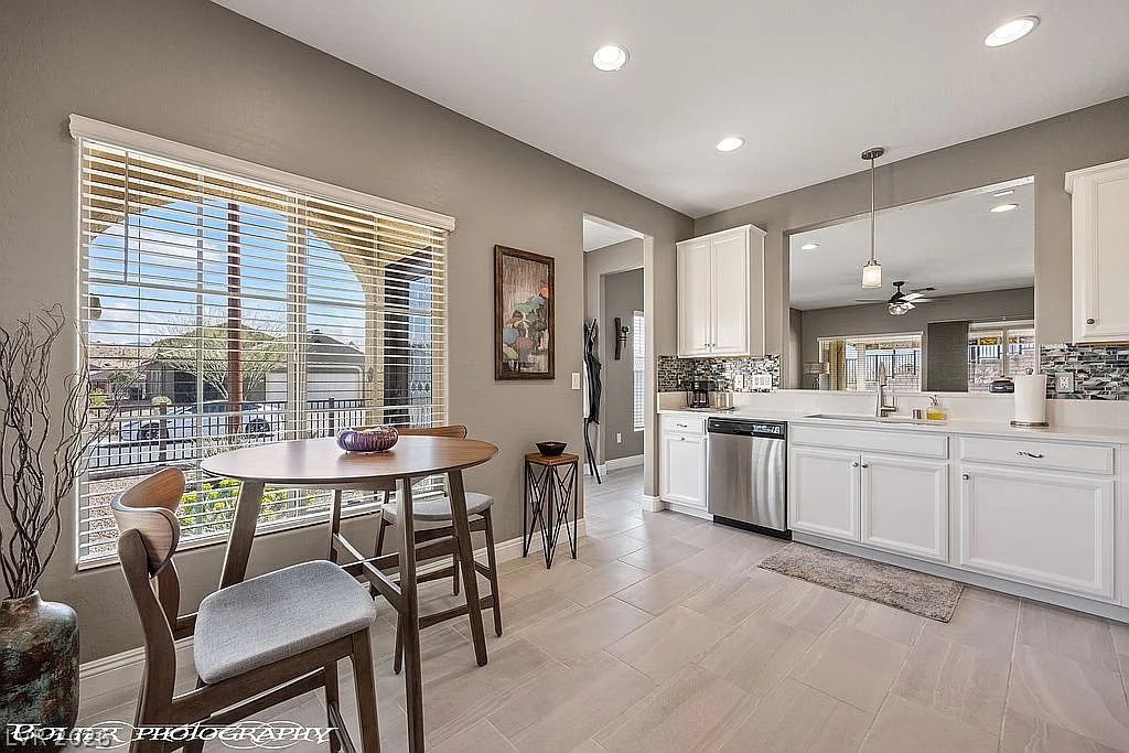 1304 Cottage Ridge Mesquite, NV 89034 - Photo 10 of 52 Clean lines and light-toned tile flooring define this bright kitchen and breakfast nook.