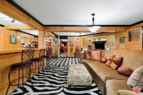 a living room with furniture a flat screen tv and a window