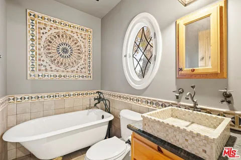 a living room with fireplace furniture and windows