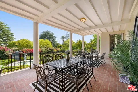 a view of a a dining room with furniture window and wooden floor