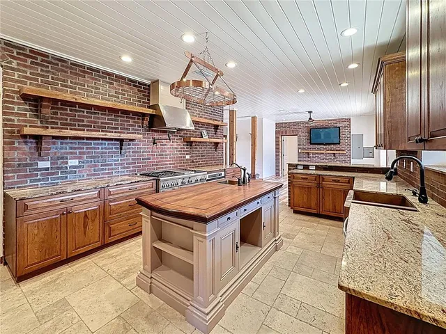 a patio with table and chairs with potted plants