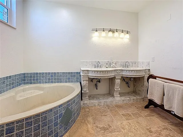 a dining room with furniture a chandelier and wooden floor