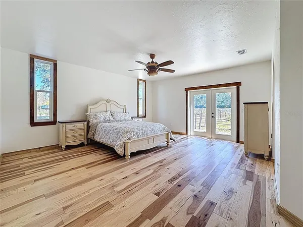 a bedroom with a bed and a chandelier