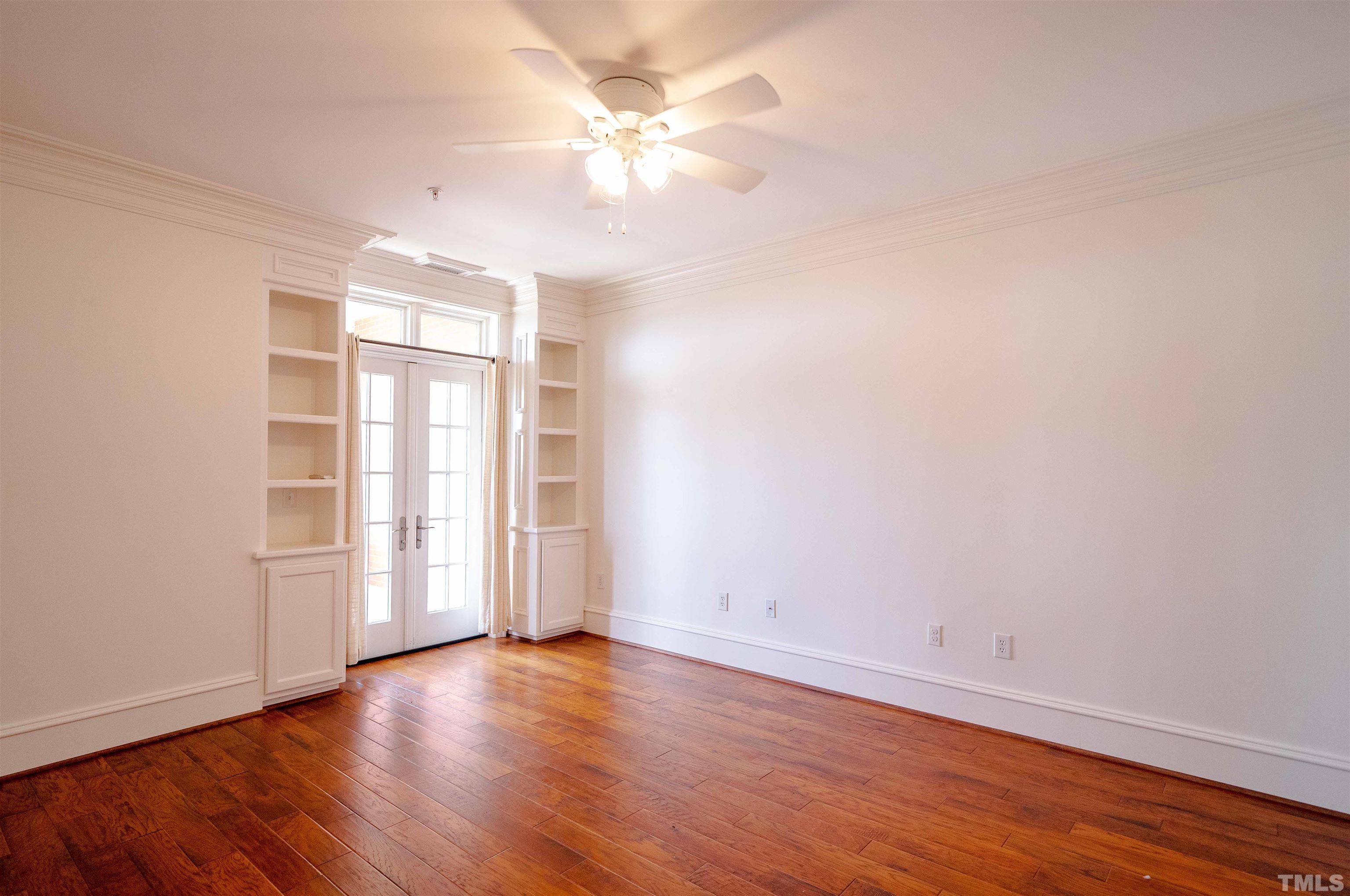 710 Independence Place, Unit 407 Raleigh, NC 27603 - Photo 5 of 10 an empty room with wooden floor and window