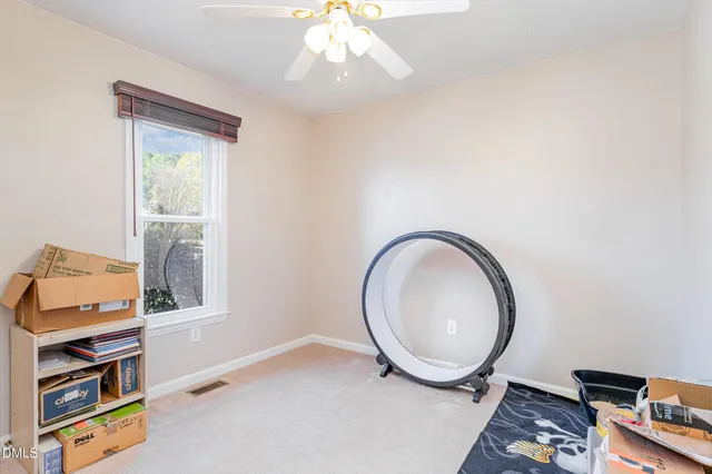 a view of a house with a yard and wooden fence