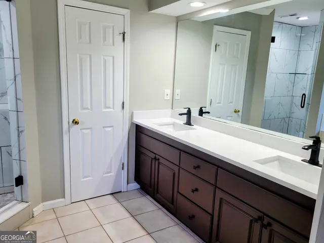 a bathroom with a double vanity sink a and mirror