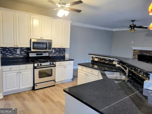 a kitchen with a stove and a microwave