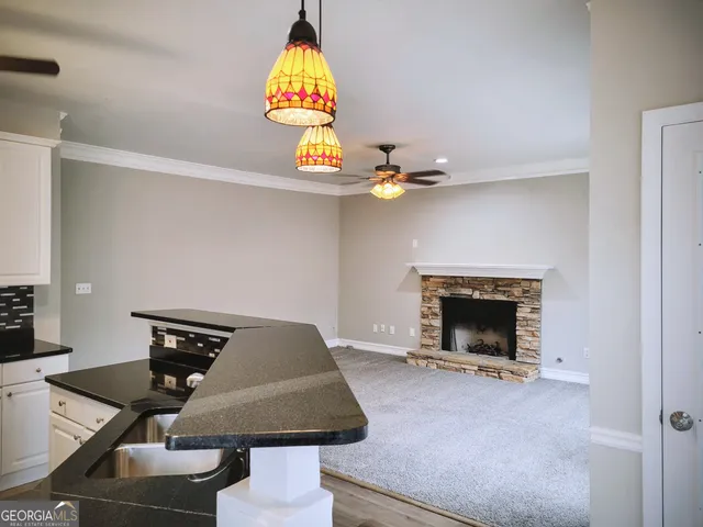 a living room with furniture and chandelier