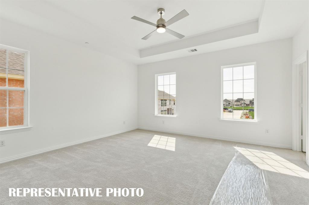 1415 Rooted Road Frisco, TX 75033 - Photo 8 of 15 Offering high ceilings, large windows and plush carpeting, this owner's bedroom is a peaceful retreat where you can relax and renew. REPRESENTATIVE PHOTO