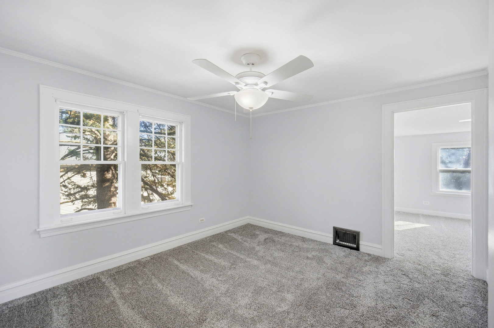 1489 East Algonquin Road Des Plaines, IL 60016 - Photo 15 of 34 an empty room with windows and ceiling fan