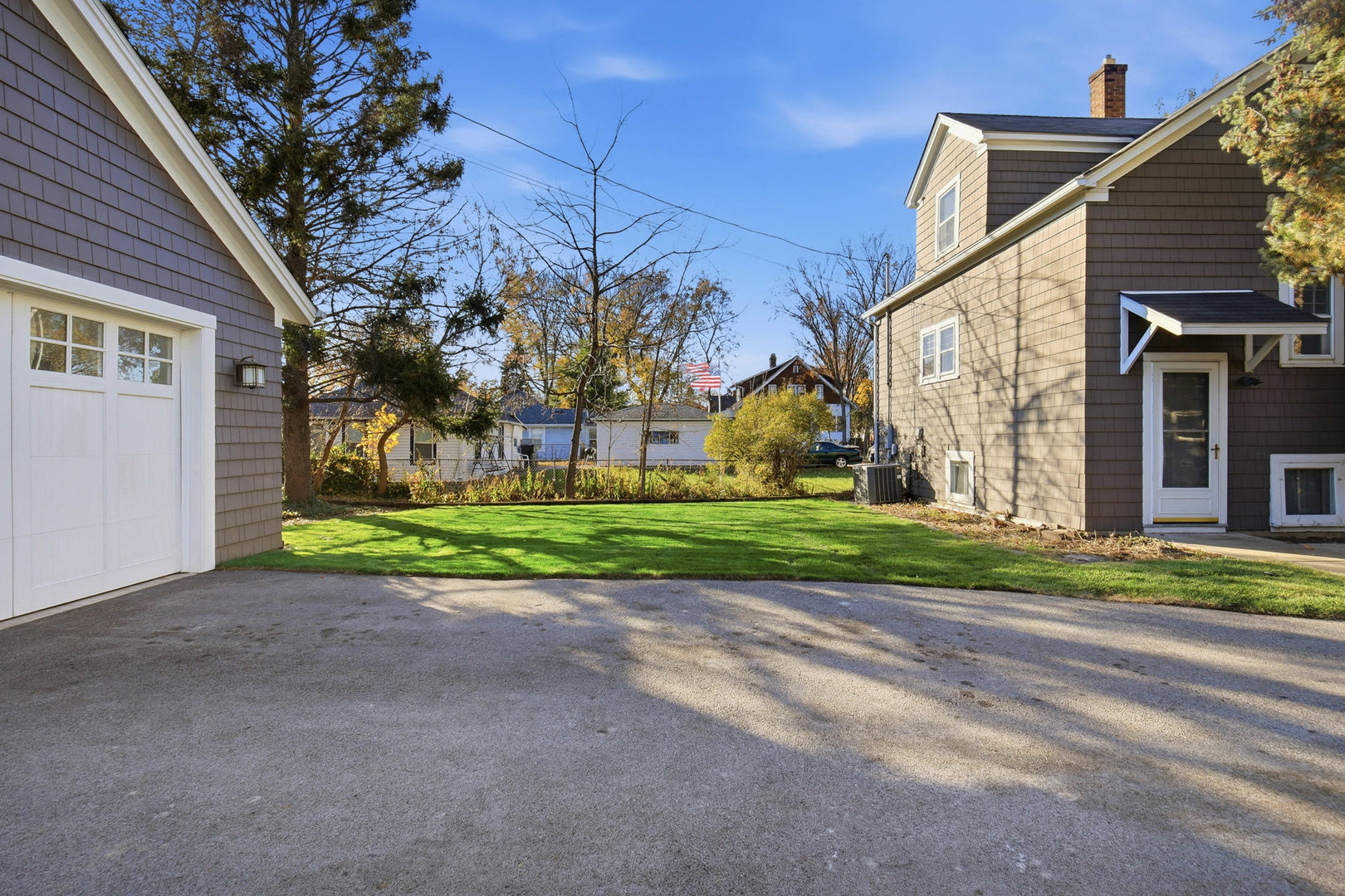 1489 East Algonquin Road Des Plaines, IL 60016 - Photo 25 of 34 a view of a house with a yard and large tree