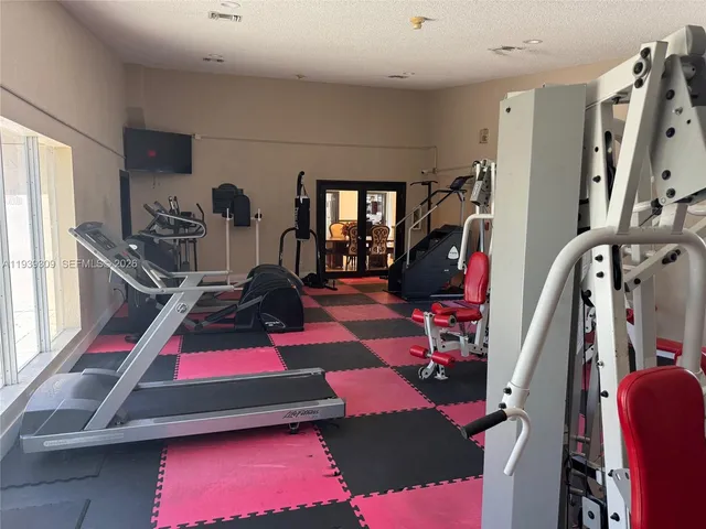 a living room with furniture and large windows