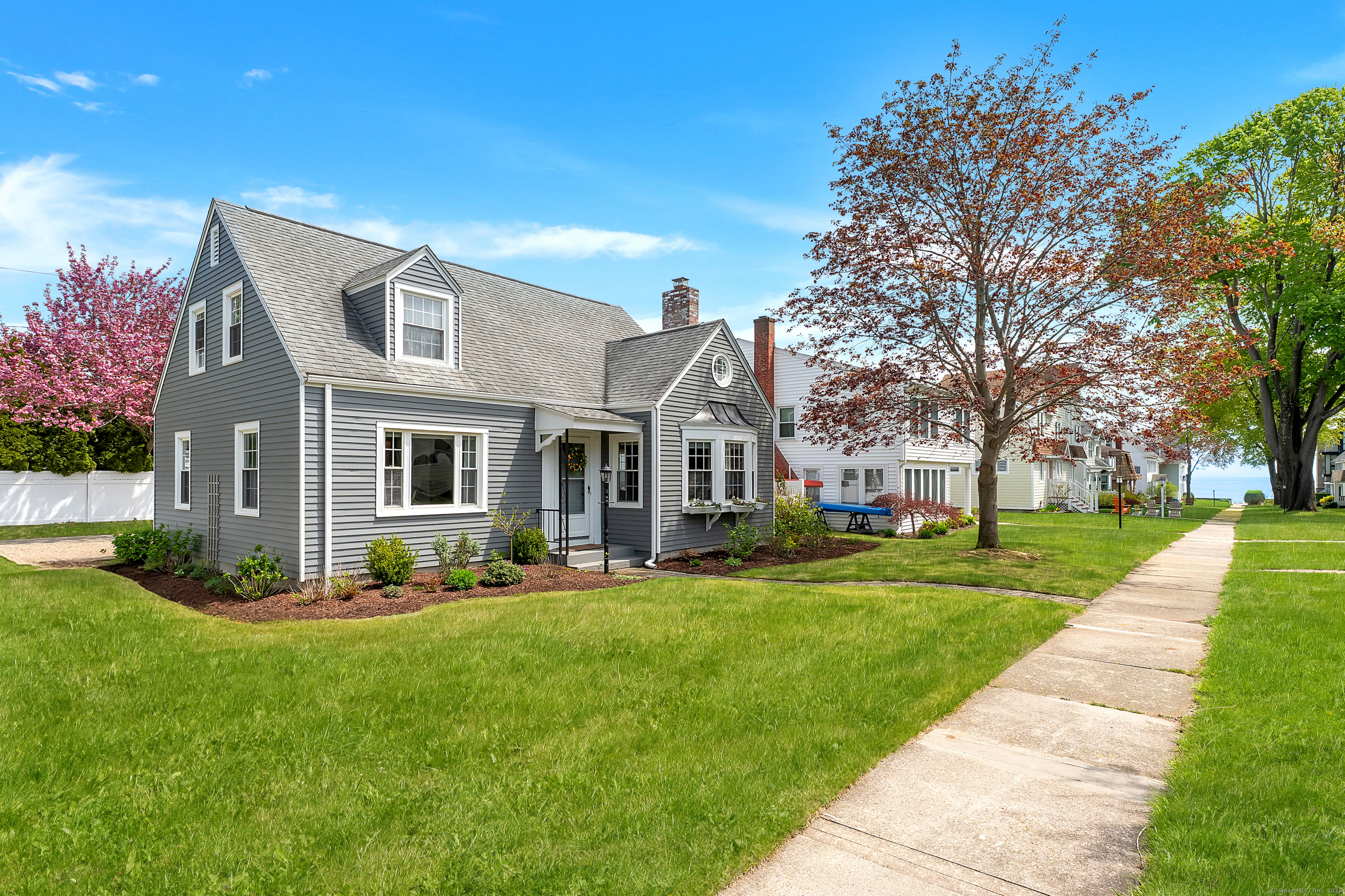 a front view of house with yard and green space