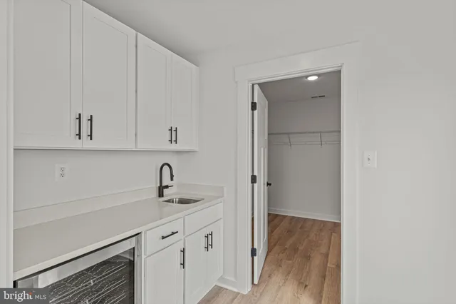 an entryway with wooden floor and a door
