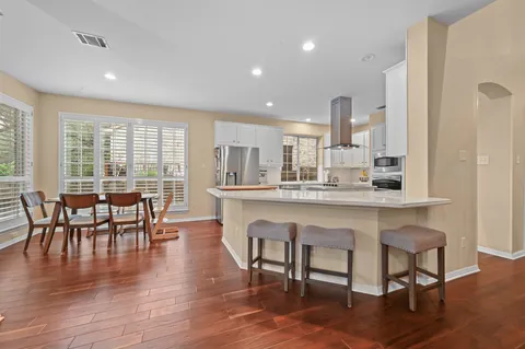 a dining room with furniture window and wooden floor
