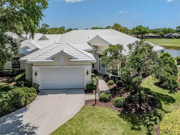 a view of a house with a yard and garage