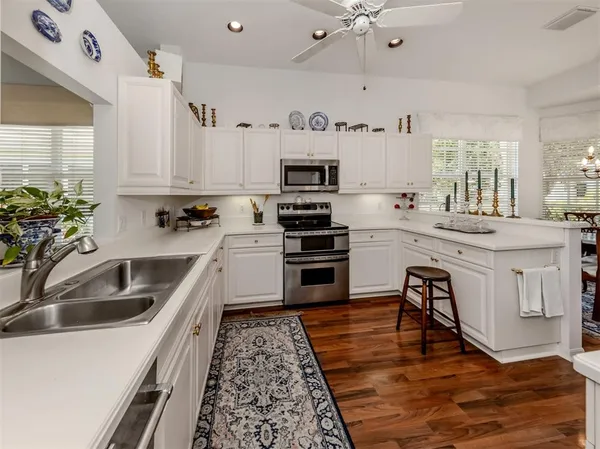 a kitchen with a sink cabinets and stainless steel appliances