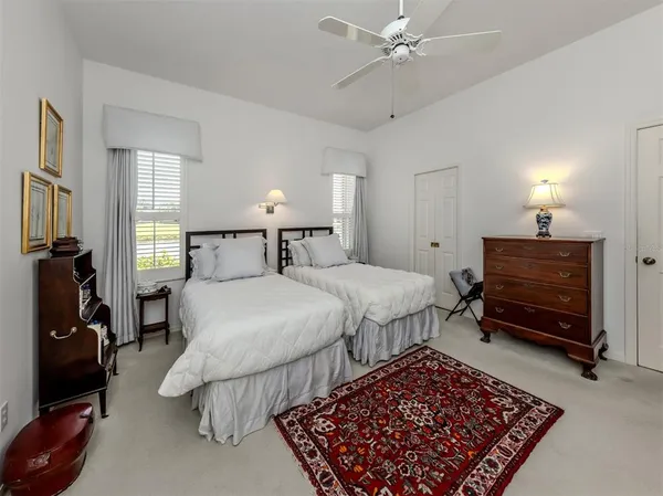 a bedroom with bed and a chandelier